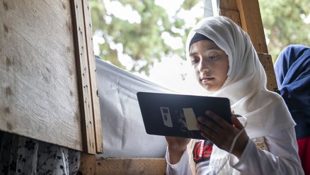 Girl Laila learns through tablet education in Lebanon_Can't Wait to Learn_War Child_200802